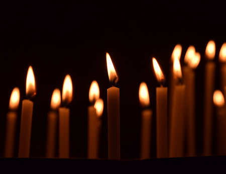 Many candles burning, all soul's day, candlelight, dark backgroundの写真素材