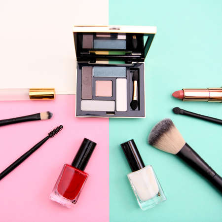 Set of cosmetic makeup: shadows, brushes, lipstick on background, top viewの写真素材
