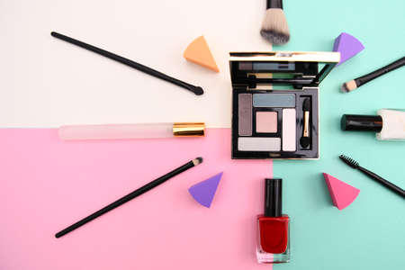 Set of cosmetic makeup: shadows, brushes, lipstick on background, top viewの写真素材