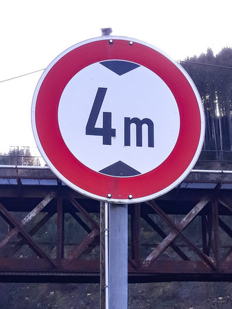 Traffic limit sign on a railway bridge. The road is closed for vehicles higher than 4 meters