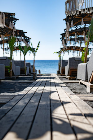 Wooden deck on the beach with the sea in the background.の写真素材