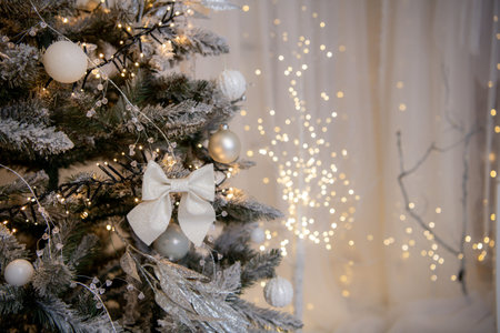 Christmas tree decorated with balls and garlands, bokeh backgroundの写真素材