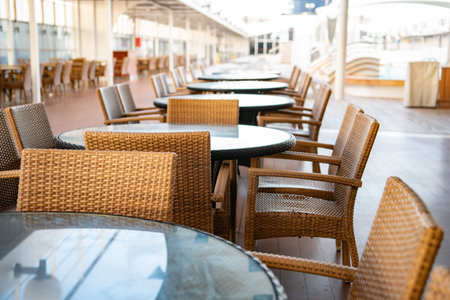 Tables and chairs in a cafe on the terrace of a cruise shipの写真素材