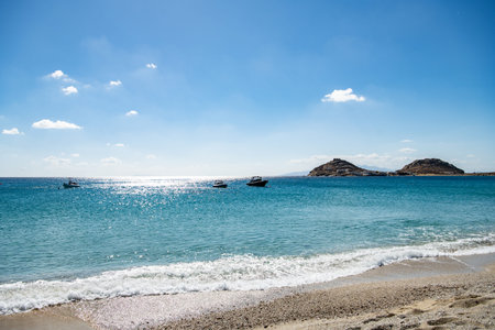 Landscape of the sea and mountains on a background of blue sky