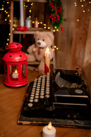 Vintage typewriter on a wooden table in a room decorated for Christmasの写真素材