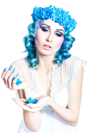 Girl with beautiful make-up and blue hair on a white background の写真素材