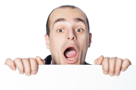 A man looks surprised to looking out for a poster on which you can write an inscription の写真素材