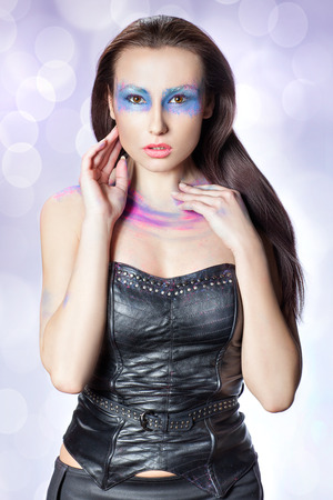Beauty portrait of a girl with makeup in the form of a mask on the eyes の写真素材