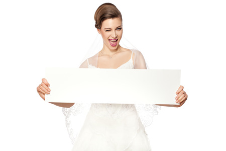 Beautiful smiling bride holding a billboard の写真素材
