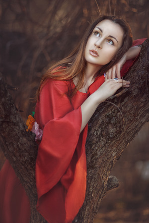 Beautiful girl dreaming under a tree missing の写真素材