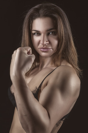 Close portrait of a girl bodybuilder with tight muscles の写真素材