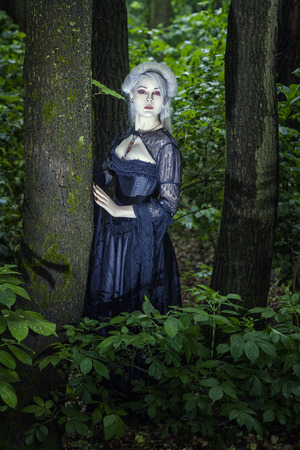 Beautiful fairy girl with white skin alone in the woods の写真素材