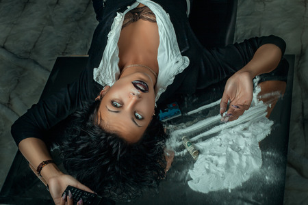 Girl lying beside drugsの写真素材