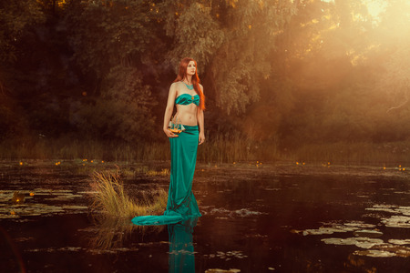 Fabulous girl of the river with a ship in the hands の写真素材