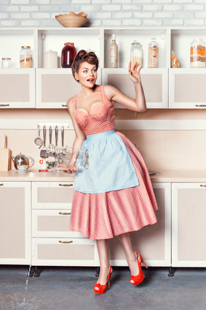 Woman lost in contemplation and poured water on the kitchen floor.の写真素材