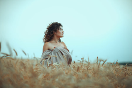 Sexy girl portrait in profile in a field of wheat.