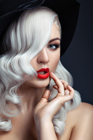 Close-up portrait of a girl with white hair and red lipstick.の写真素材