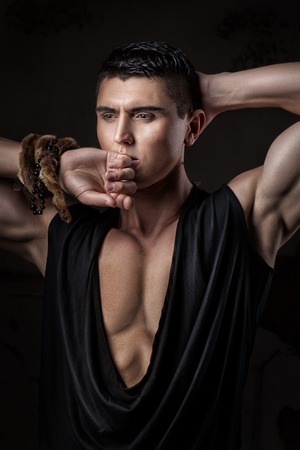 Handsome guy is an athlete with sad eyes. Beautiful figure.の写真素材