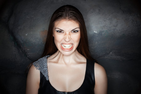 Portrait of a girl with a grimace of anger on his face.