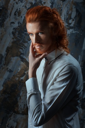 Portrait of a man with fiery curls on his head on the face of freckles.の写真素材