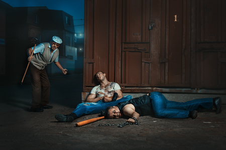 At night, on the street an old man, he beat bandits.の写真素材