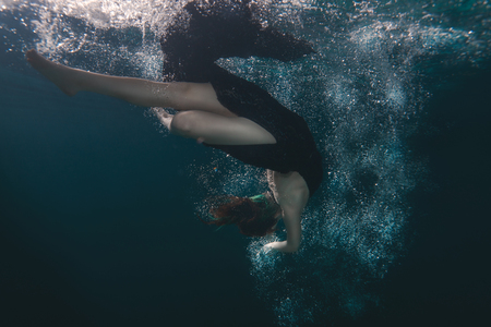 She floats among the splashing water and light.の写真素材