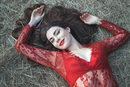 The girl's luxuriant hair, she lay on the straw.の写真素材