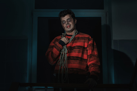 Scary man killer with a knife in the room.の写真素材