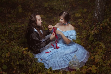 Girl and the man tied its own hands, they are dressed in retro style.の写真素材