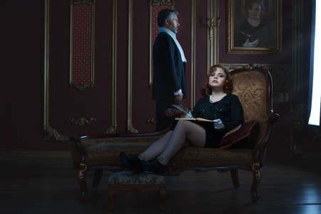 Rich and noble woman and a man in a spacious room.の写真素材