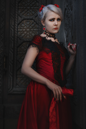 Woman in vintage red dress with lace.の写真素材