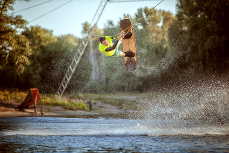 Jumping on a wakeboard on the water, an extreme sport.の写真素材