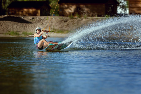 Waking on wakeboarding summer sport, a woman trains.の写真素材