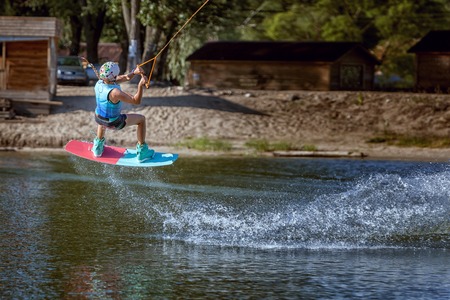 Jump over the water on a wakeboard, an extreme sport.の写真素材