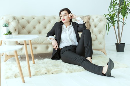 Bold woman sitting on the floor, she misses.の写真素材