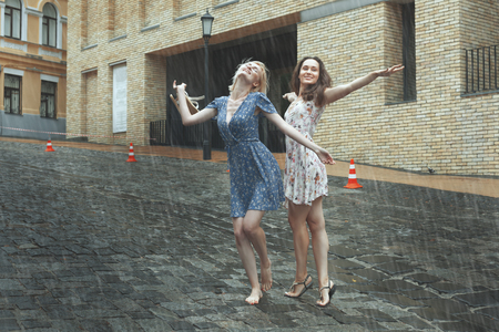 Women are happy with the rain, they are happy and dancing in the rain.の写真素材
