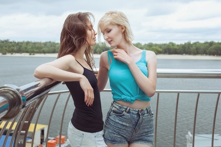 Woman flirting with a friend, she touches her hair.の写真素材