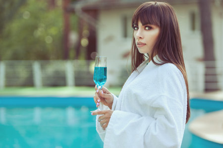 Portrait of a beautiful woman with a glass of wine.の写真素材
