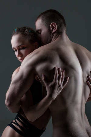 Man and a woman are embraced, they have beautiful slender athletic figures.の写真素材