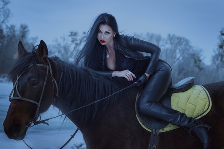 Woman is a vamp on a horse, in the style of dark.の写真素材