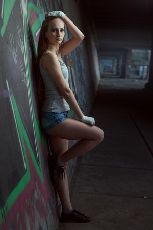 Portrait of a beautiful young woman fighter under the bridge.の写真素材