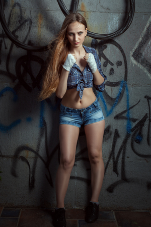 Portrait of a beautiful fighter girl. She's standing in a fighting stance..の写真素材