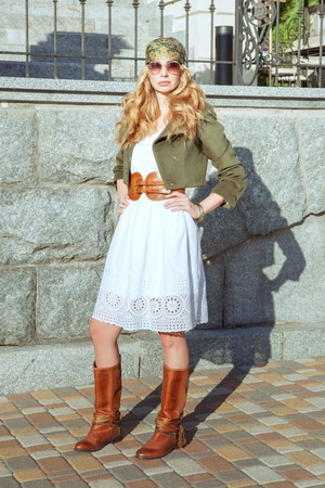 Portrait of a beautiful blonde woman. She is dressed in the style of a boho.の写真素材