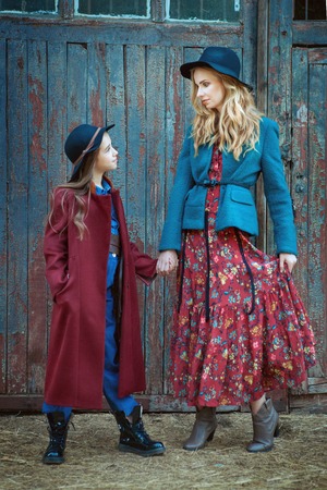 Portrait of beautiful mother and daughter. They hold hands.の写真素材