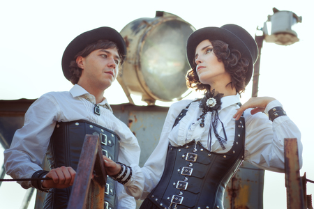 Couple in love in the style of steampunk. They are dressed in retro costumes and corsets.の写真素材