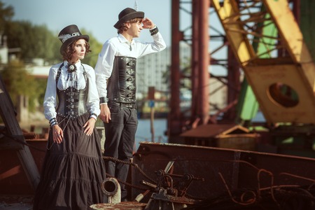 Man and a woman in the style of steampunk, they have costumes of leather corsets.の写真素材