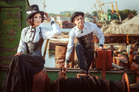 People in retro style steampunk, near the mechanisms of old machines.の写真素材