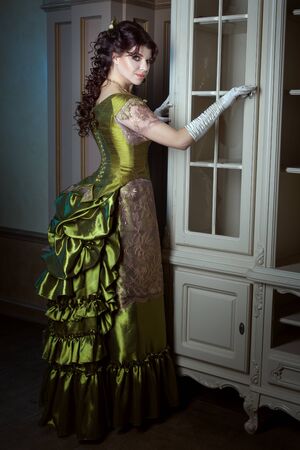 Woman in openwork and magnificent dress of retro style, gloves are on hands.の写真素材