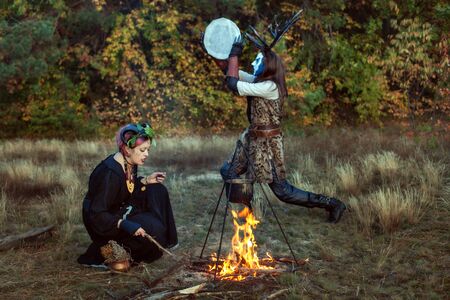 Shamans conduct ritual rites in the forest. They make a magic potion.の写真素材