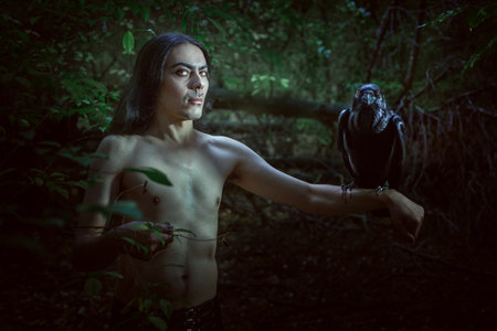 A creepy man with a raven on his hand looks like a demon.